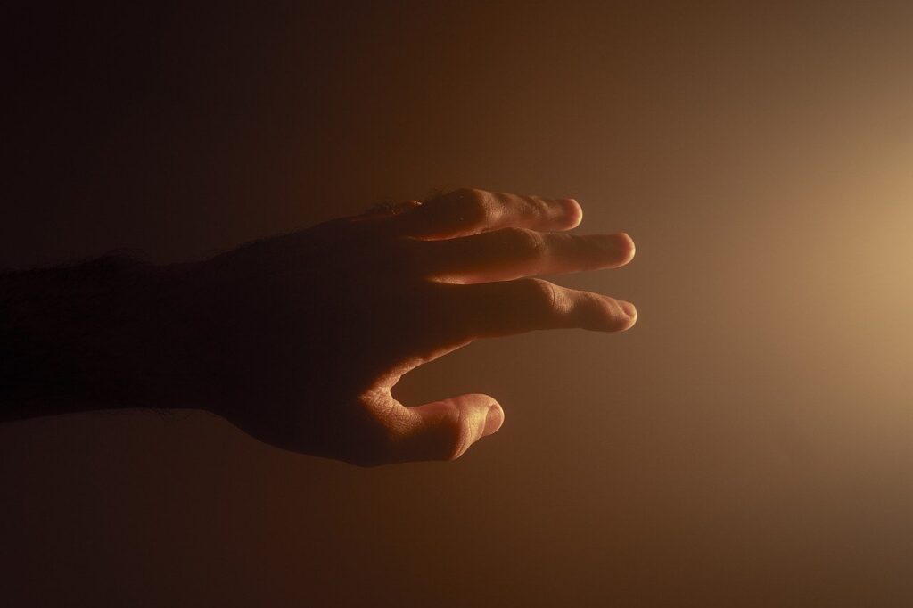 Photo of a hand reaching out, symbolizing empathy