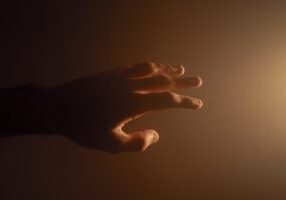 Photo of a hand reaching out, symbolizing empathy