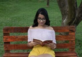 Photo of a female reader on a bench